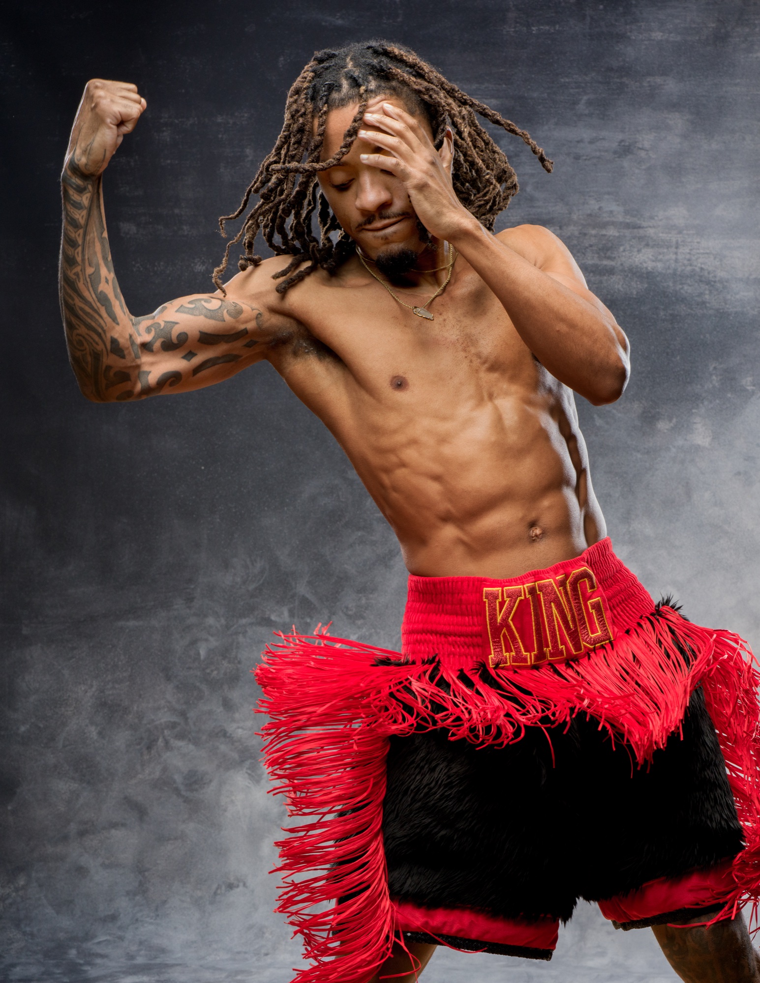 Boxer in red KING shorts mid-pose at the Uptown Loft.