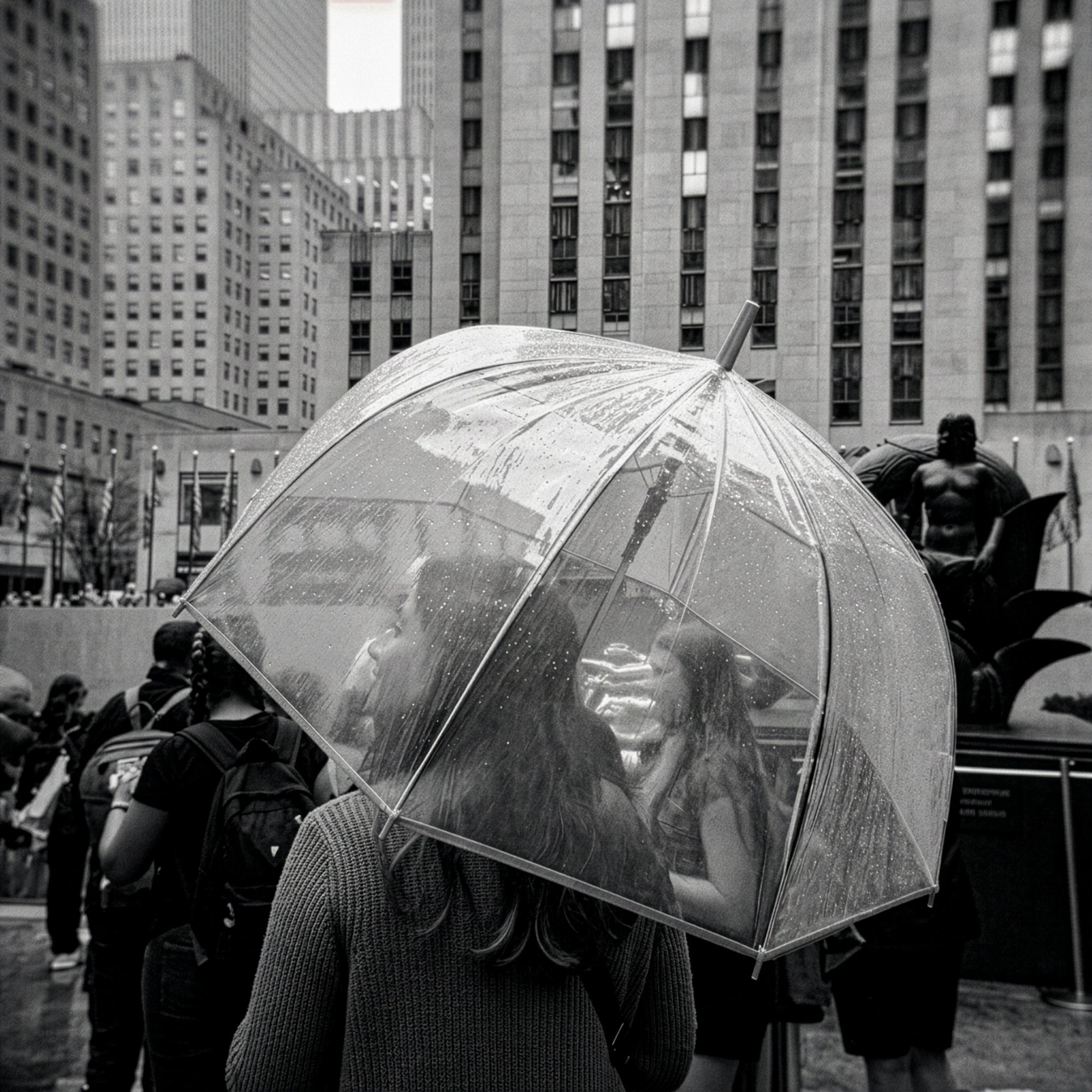 Rockefeller Center, NYC — couple beneath a clear umbrella, B&W, by G. John Slagle.