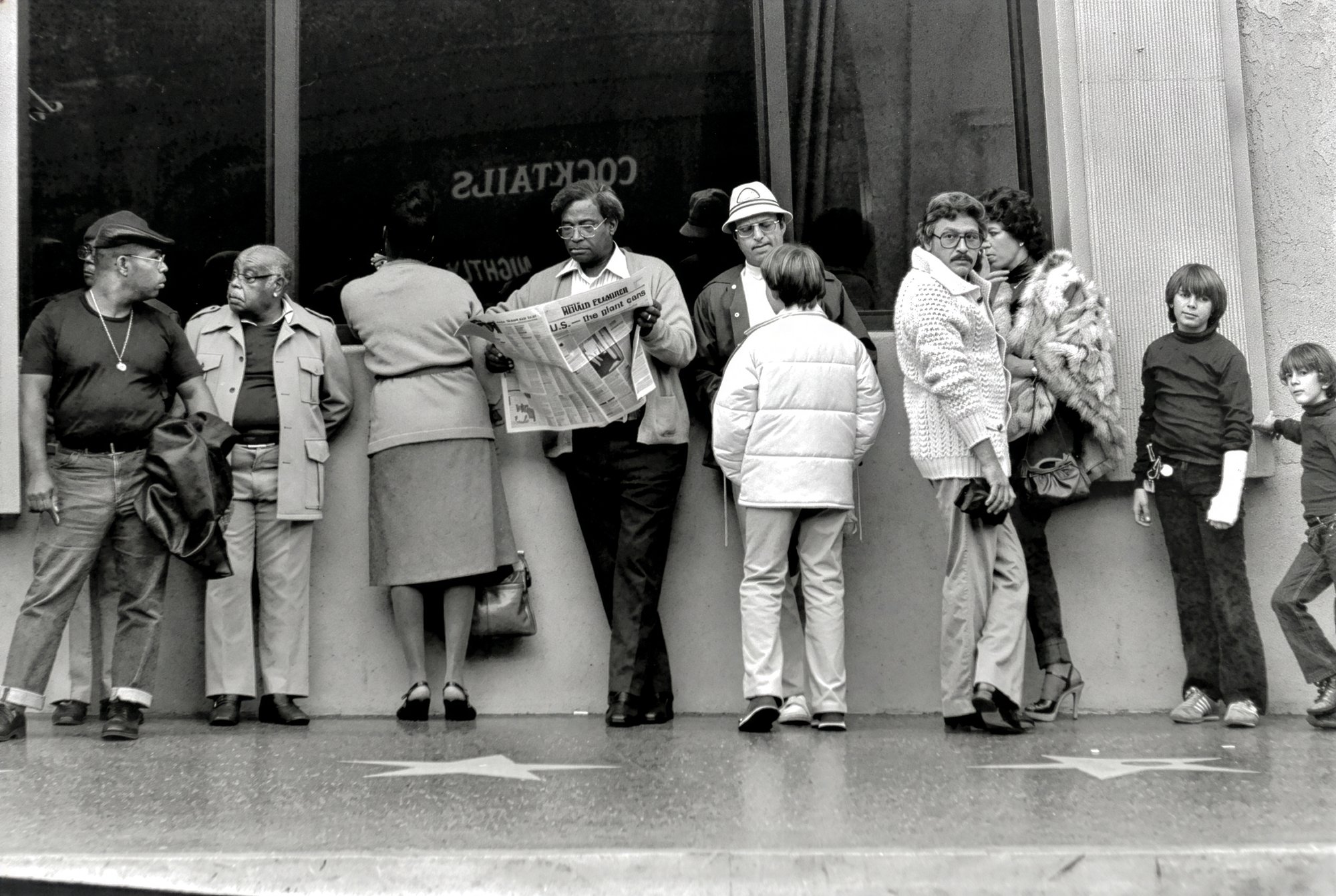 A line of bystanders along Hollywood Boulevard's Walk of Fame stars.